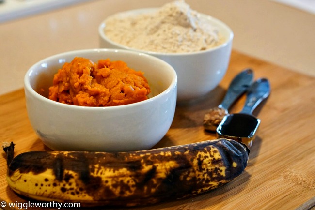 Ingredients for pumpkin banana dog treat recipe arranged on bamboo board Ingredients for pumpkin banana dog treat recipe arranged on bamboo board